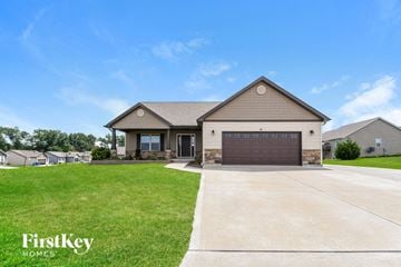 Troy house for rent - a house with a driveway and a garage door