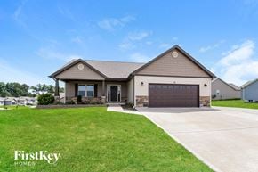 Troy house for rent - a house with a driveway and a garage door