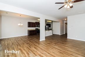 Dallas house for rent - A spacious living room with wooden floors and a ceiling fan.