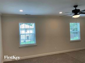 Concord house for rent - a living room with two windows and a ceiling fan