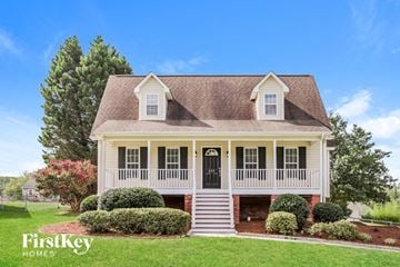 Lexington house for rent - a white house with a black door and a lawn