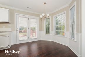 Lexington house for rent - an empty dining room with windows and a door to a balcony