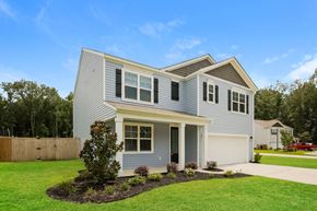 Moncks Corner house for rent - A house with a grey and yellow exterior and a white garage door.