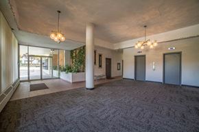 Vancouver apartment for rent - a large room with a carpeted floor and a lobby with doors