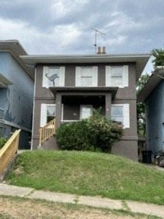Donora house for rent - A house with a grey and brown exterior and a white door.