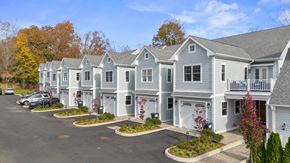 Guilford apartment for rent - a row of town homes with cars parked in front of them