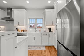 Guilford apartment for rent - a kitchen with white cabinets and a stainless steel refrigerator