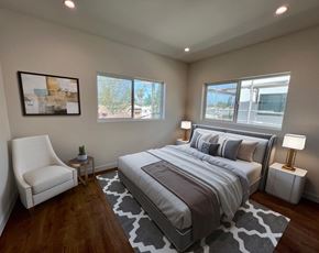 North Hollywood apartment for rent - a bedroom with a bed and three windows