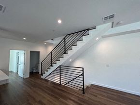 North Hollywood apartment for rent - a white staircase in a house with a wooden floor