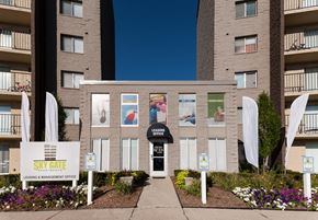 Westland apartment for rent - an apartment building with a walkway and a sign in front of it