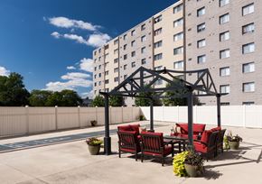 Westland apartment for rent - a patio with red chairs and a table under a gazebo