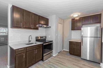 Hazel Park apartment for rent - a kitchen with wooden cabinets and stainless steel appliances