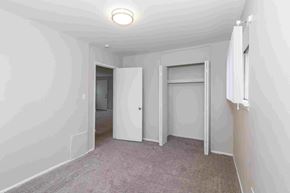 Hazel Park apartment for rent - a bedroom with white walls and carpet and a door to a closet