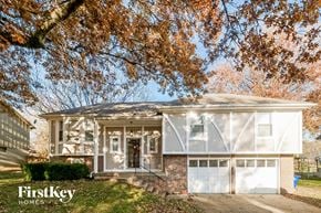 Lenexa house for rent - a brick house with a tree in front of it