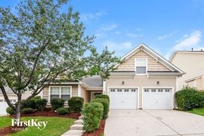 Charlotte house for rent - A house with a tree in front and the words "FirstKey Homes" on the lawn.