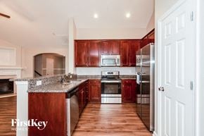 Charlotte house for rent - A kitchen with wooden cabinets and a granite countertop.