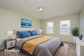 Mckinney house for rent - A bedroom with a bed, nightstands, and a painting on the wall.