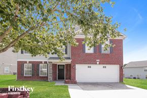 Charlotte house for rent - a red brick house with a white garage door