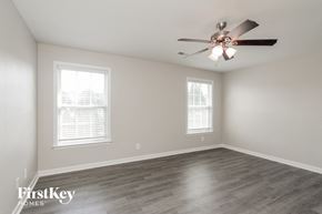 Charlotte house for rent - a living room with a ceiling fan and two windows