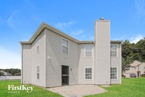 Charlotte house for rent - a white house with a ramp in front of a grass field