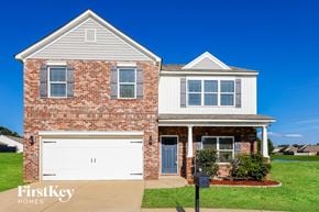 Bessemer house for rent - a red brick house with a white garage door