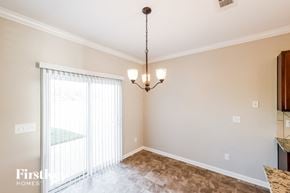 Bessemer house for rent - a dining room with a large window and a chandelier