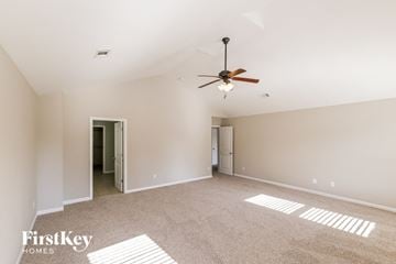 Bessemer house for rent - a spacious living room with carpet and a ceiling fan