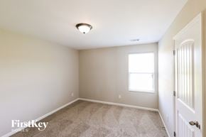 Bessemer house for rent - a bedroom with carpet and a white door and a window