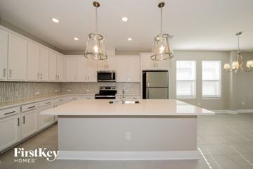 Bradenton house for rent - A kitchen with a white counter top and cabinets.