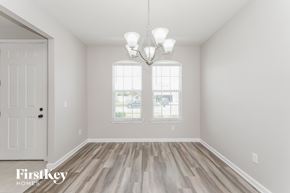 Parrish house for rent - A room with a white door and a chandelier hanging from the ceiling.