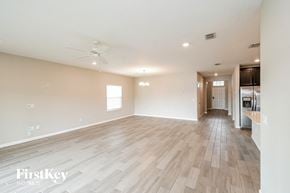Jacksonville house for rent - the living room is spacious with hardwood floors and a kitchen