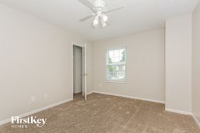 Springboro house for rent - a bedroom with carpet and a ceiling fan