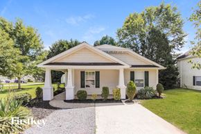 Mooresville house for rent - a small white house with white pillars and a driveway