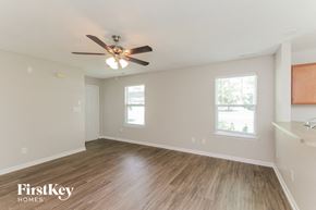 Mooresville house for rent - a living room with hardwood floors and a ceiling fan