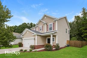Moncks Corner house for rent - A house with a garage and a brick wall.