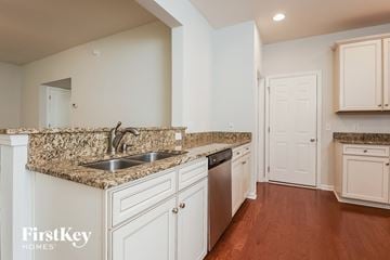 Moncks Corner house for rent - A kitchen with a granite counter top and white cabinets.