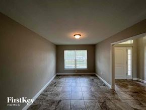Punta Gorda house for rent - an empty living room with tile flooring and a window