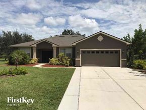 Lehigh Acres house for rent - A house with a garage and a driveway in front of it.