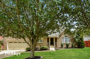Mount Juliet house for rent - A tree in front of a house with a garage door.