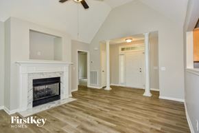 Mount Juliet house for rent - A spacious living room with a fireplace and wooden flooring.