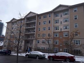 Waterloo apartment for rent - A car is parked in a parking lot in front of a building.