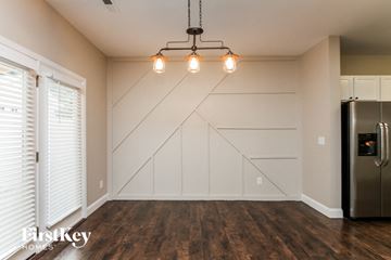 Cornelius house for rent - A kitchen with a stainless steel refrigerator and wooden flooring.