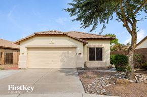 Avondale house for rent - a house with a white garage door and a tree