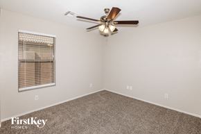Avondale house for rent - a bedroom with a ceiling fan and a window
