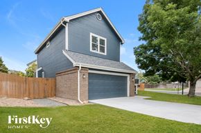 Thornton house for rent - a blue house with a driveway and a blue garage door