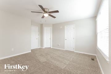 Thornton house for rent - a spacious living room with carpet and a ceiling fan