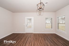 Odenville house for rent - A room with wooden floors and a white door.