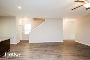 Dawsonville house for rent - a living room with white walls and wood flooring and a ceiling fan