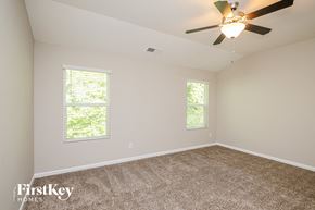 Dawsonville house for rent - the master bedroom has a carpeted floor and a ceiling fan