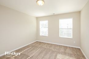 Dawsonville house for rent - a spacious room with carpet and two windows